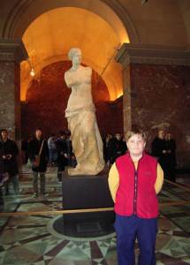 Joshua in front of a famous statue at the Louvre